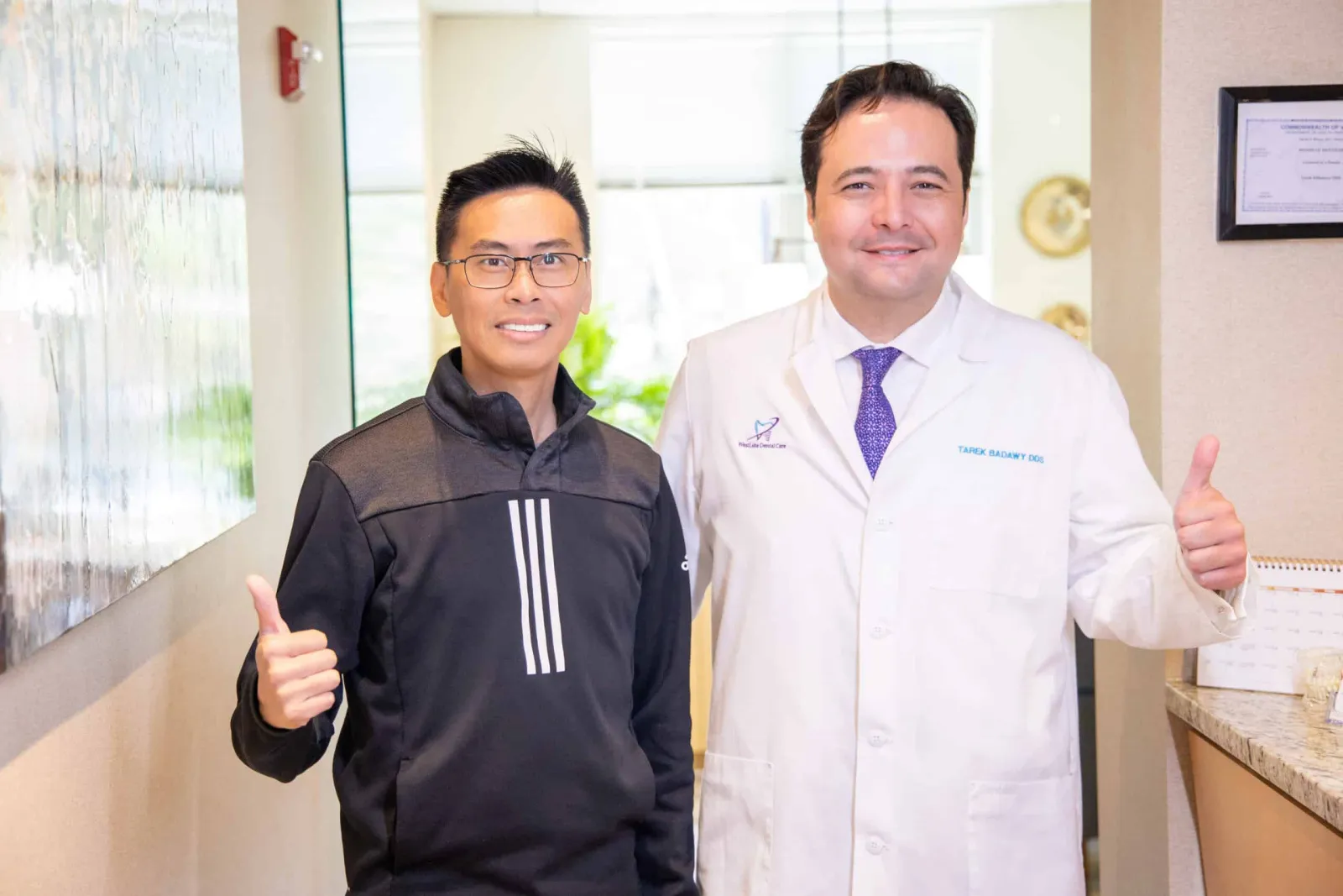 Dr. Tarek Badawy welcoming a guest at the Westlake Dental Care front desk